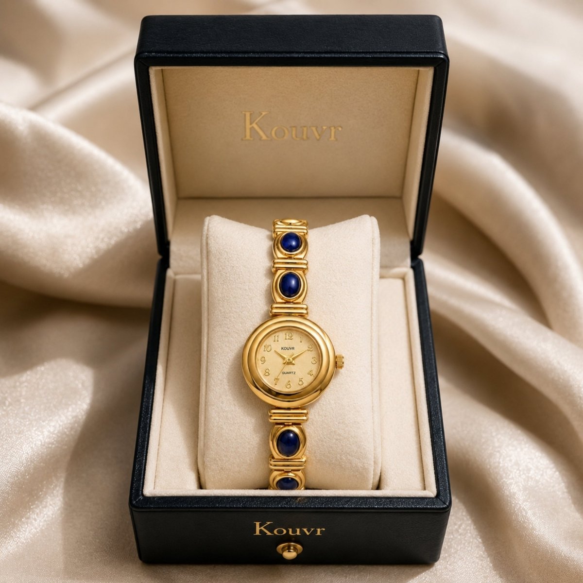 Kouvr vintage gold women's watch with deep blue stones elegantly displayed in a premium dark blue luxury presentation box.