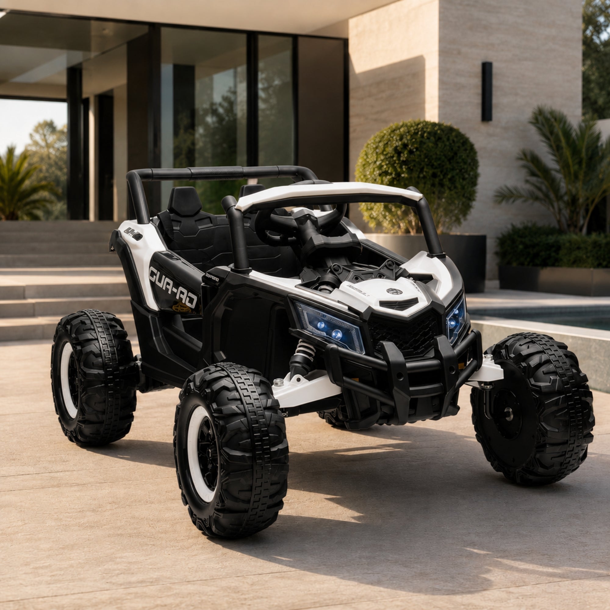 A white and black two-seater kids' electric UTV side-by-side vehicle parked on a luxury home patio with blue LED headlights turned on.
