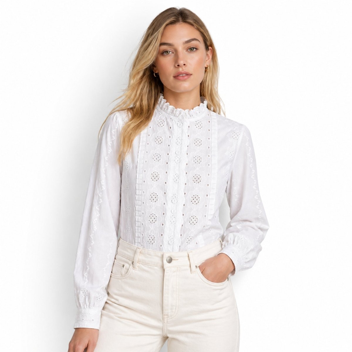 Lifestyle shot of woman with hand in pocket wearing white eyelet ruffle neck blouse by Kouvr