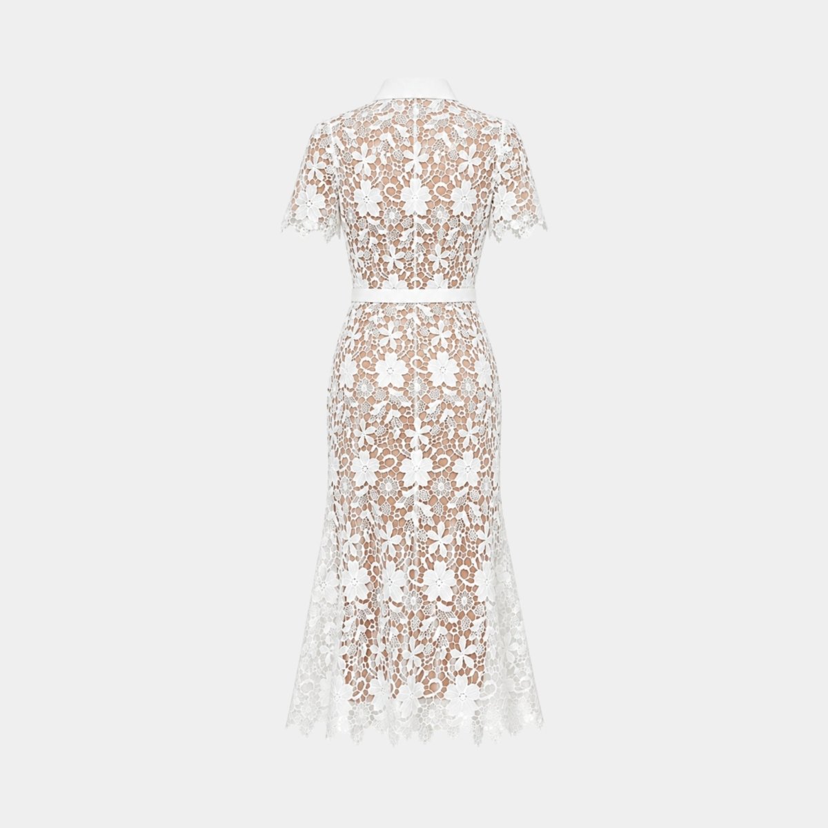 Flat lay back view of the white floral lace midi dress highlighting the intricate daisy lace pattern and full nude lining.
