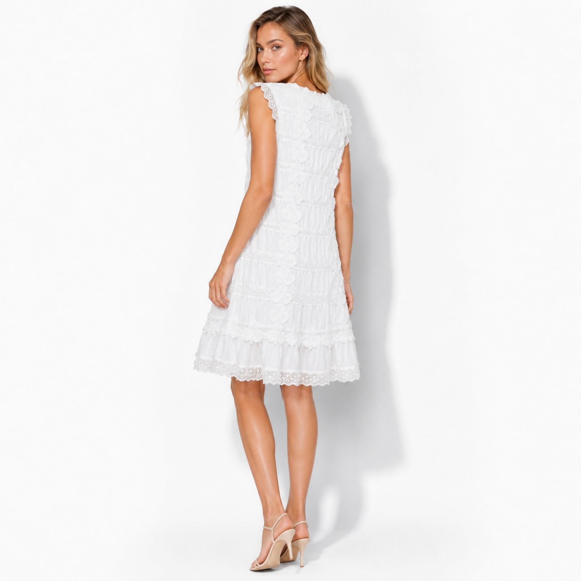 Back view of woman wearing Kouvr white romantic summer dress with scalloped hem