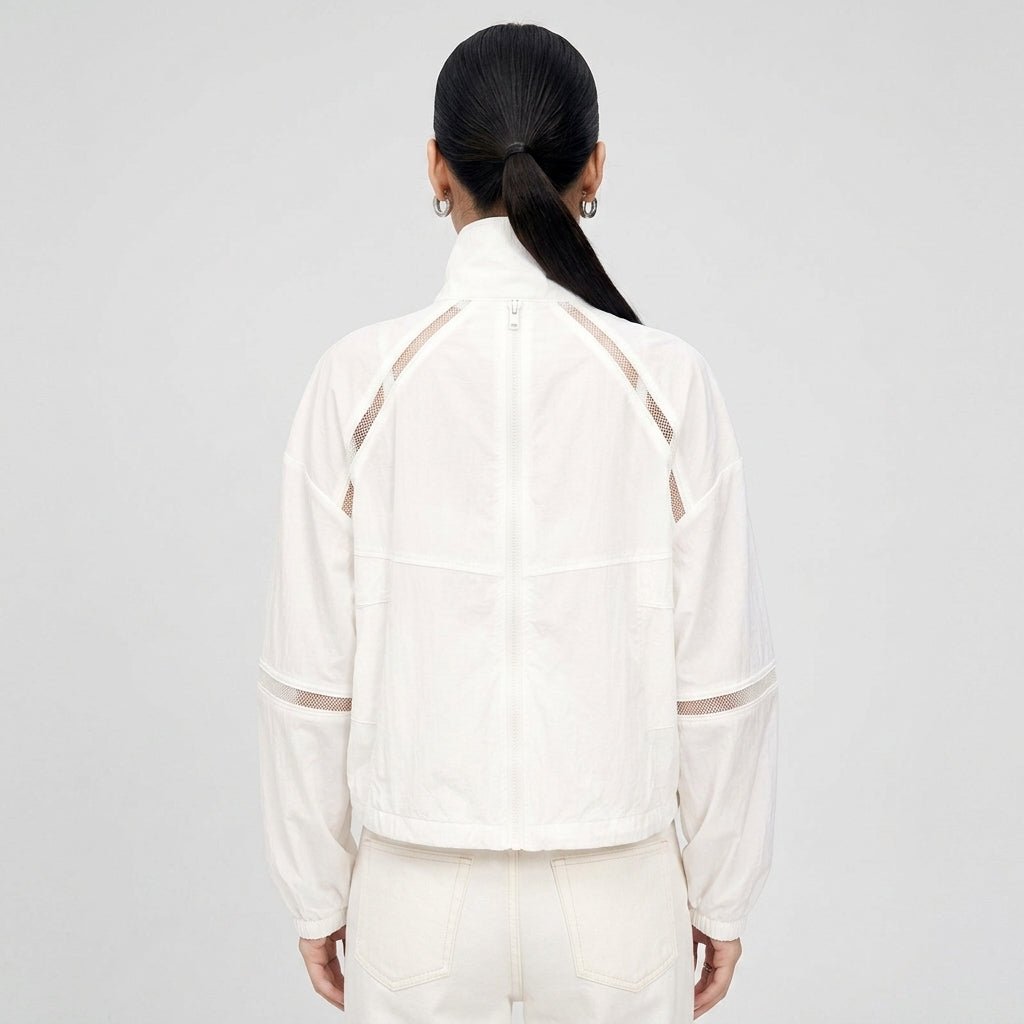 Back view of the Kouvr white lightweight windbreaker jacket highlighting sheer mesh ventilation panels