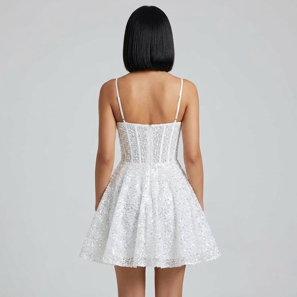 Back view of short white sequin fit and flare dress showing concealed back zipper and low back design