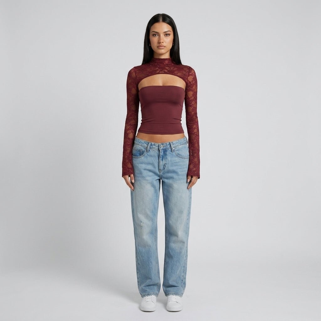 Full body style view of model wearing Kouvr wine red lace mock neck top with light wash denim jeans