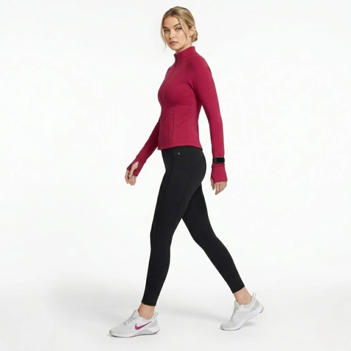 Full back view of female model in berry red premium athleisure zip jacket and black athletic leggings