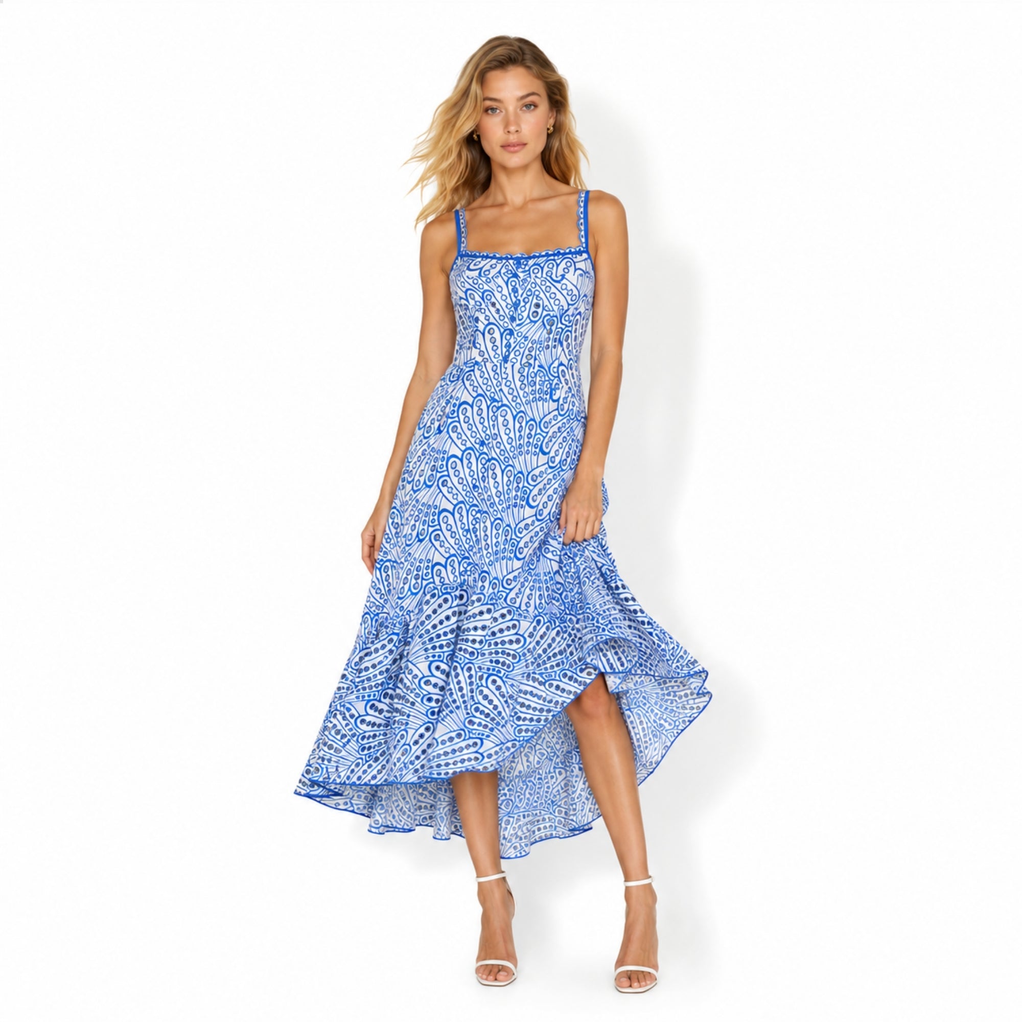 Model wearing Kouvr blue and white broderie anglaise eyelet corset midi dress with high low ruffle hem facing forward