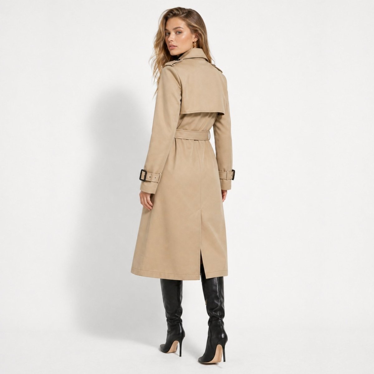 Back view of a tailored khaki trench coat showing the classic storm flap, waist belt, and deep back vent