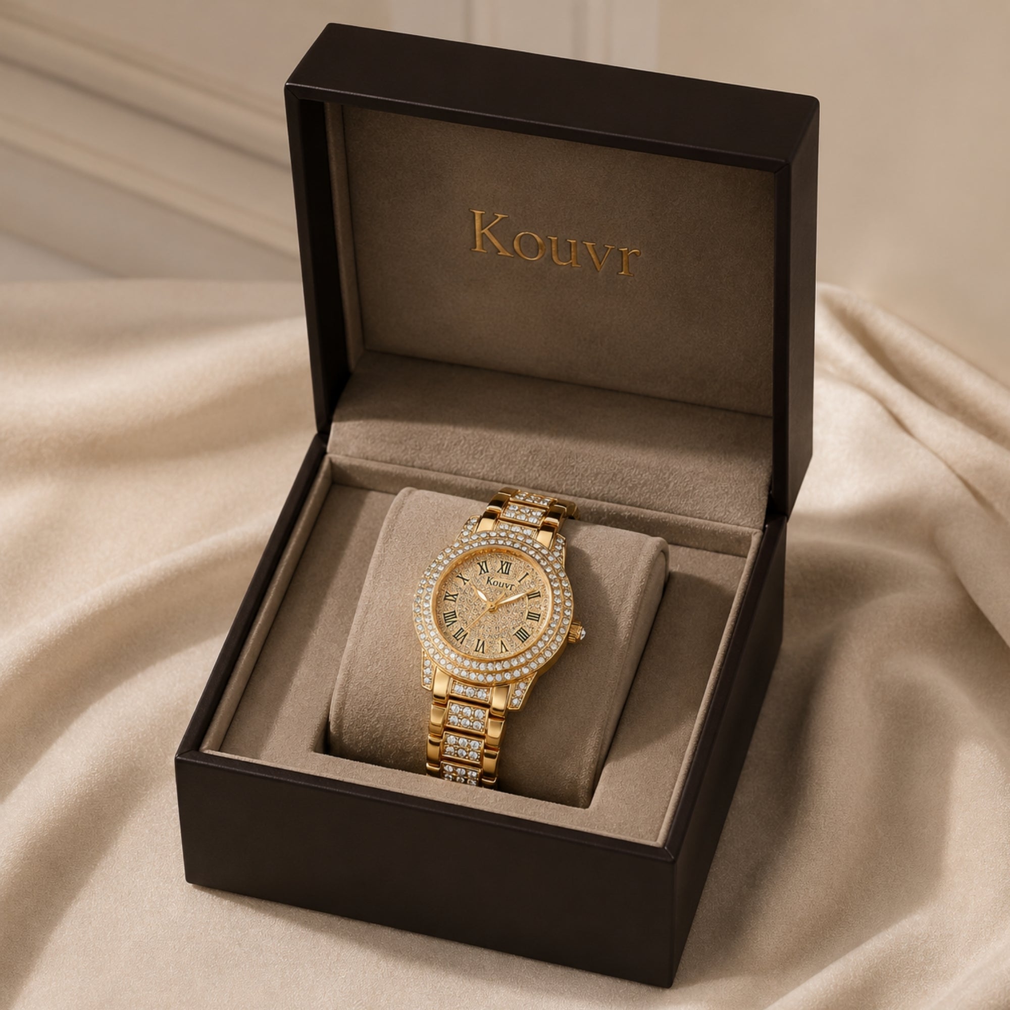 Luxury women's gold watch with sparkling crystal pave dial and bezel, displayed inside a premium black Kouvr presentation box with authenticity card.