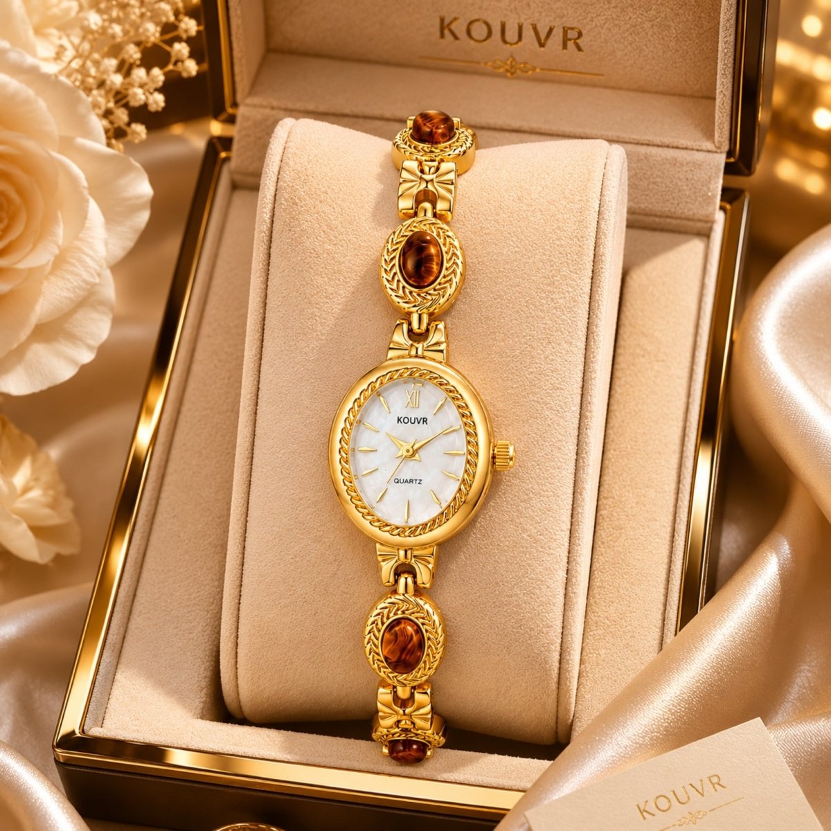 Kouvr women's gold vintage style jewelry watch with white dial and tiger eye stones displayed elegantly in a luxury beige presentation gift box.