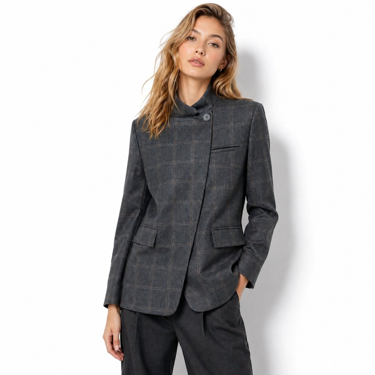 Front view of female model wearing the Kouvr grey plaid asymmetric stand collar tailored blazer jacket.