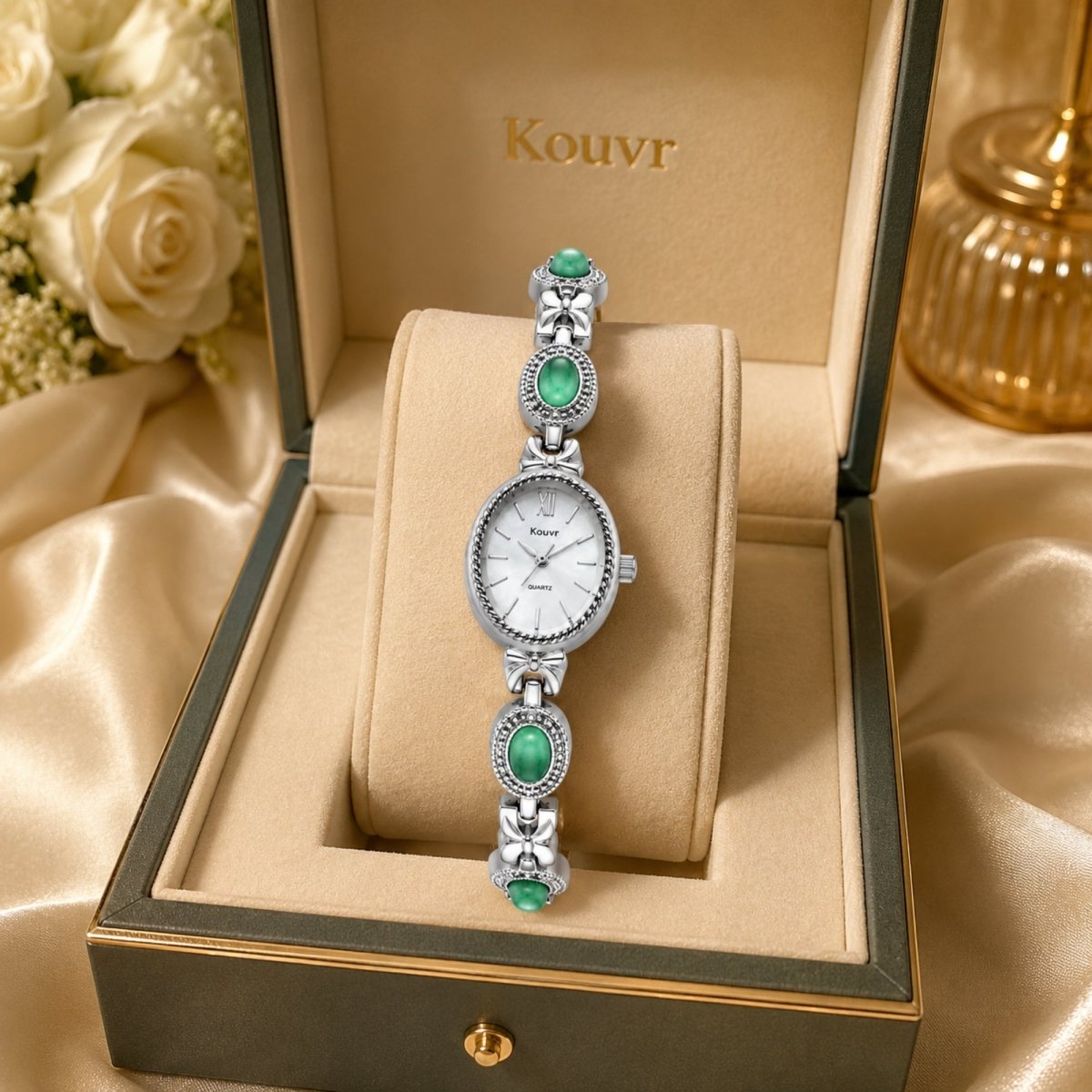 Close-up of Kouvr women's silver vintage bracelet watch featuring a white oval dial and green jade-colored gemstone links, displayed inside a premium presentation box.