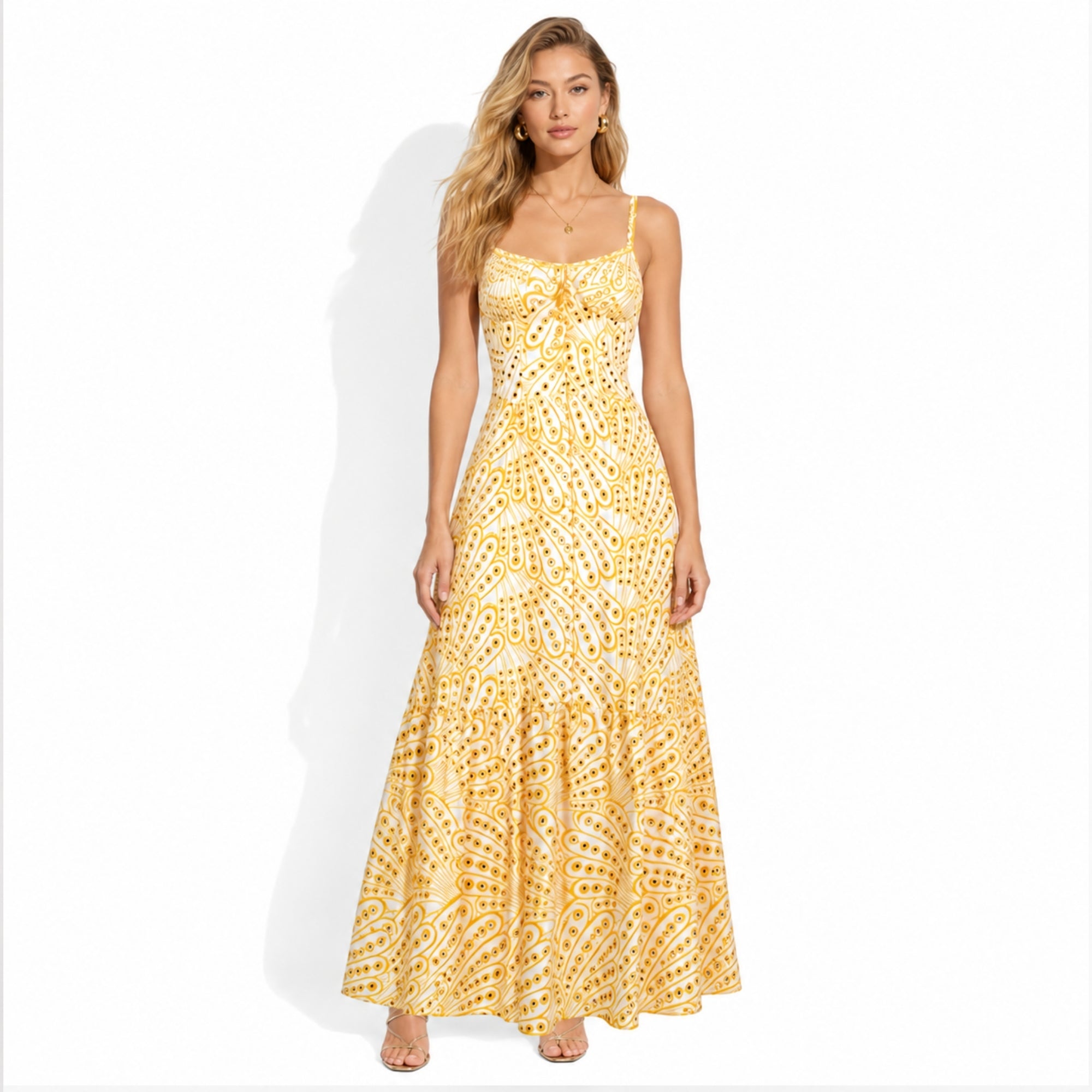 Model posing in Kouvr yellow and white floral eyelet maxi dress with sweetheart neckline and corset bodice
