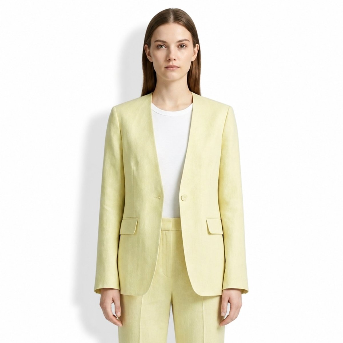 Woman wearing Kouvr yellow collarless linen blazer with white tee, facing forward.