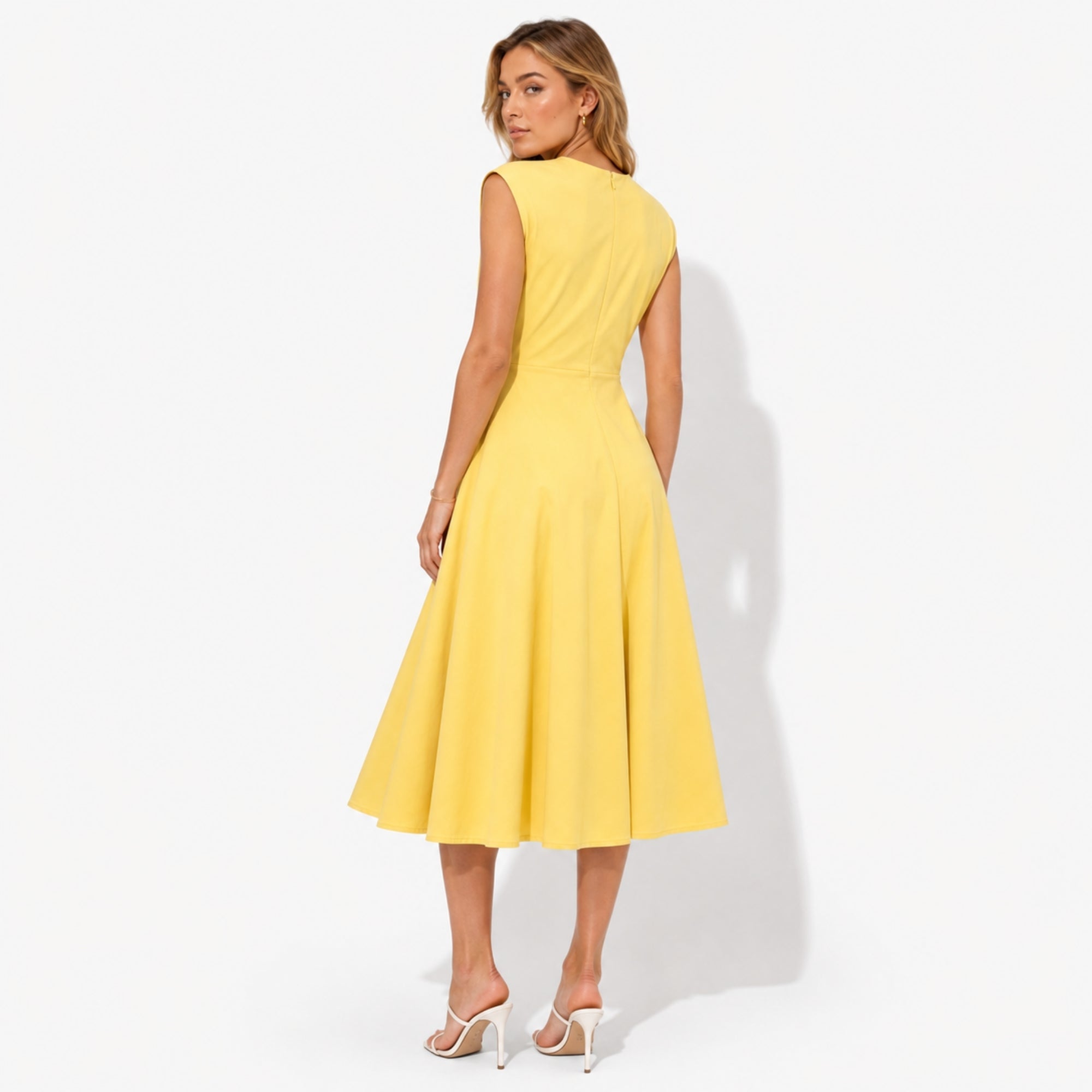 Back view of yellow sleeveless crewneck midi dress showing a seamless concealed zipper and elegant sweeping hemline.