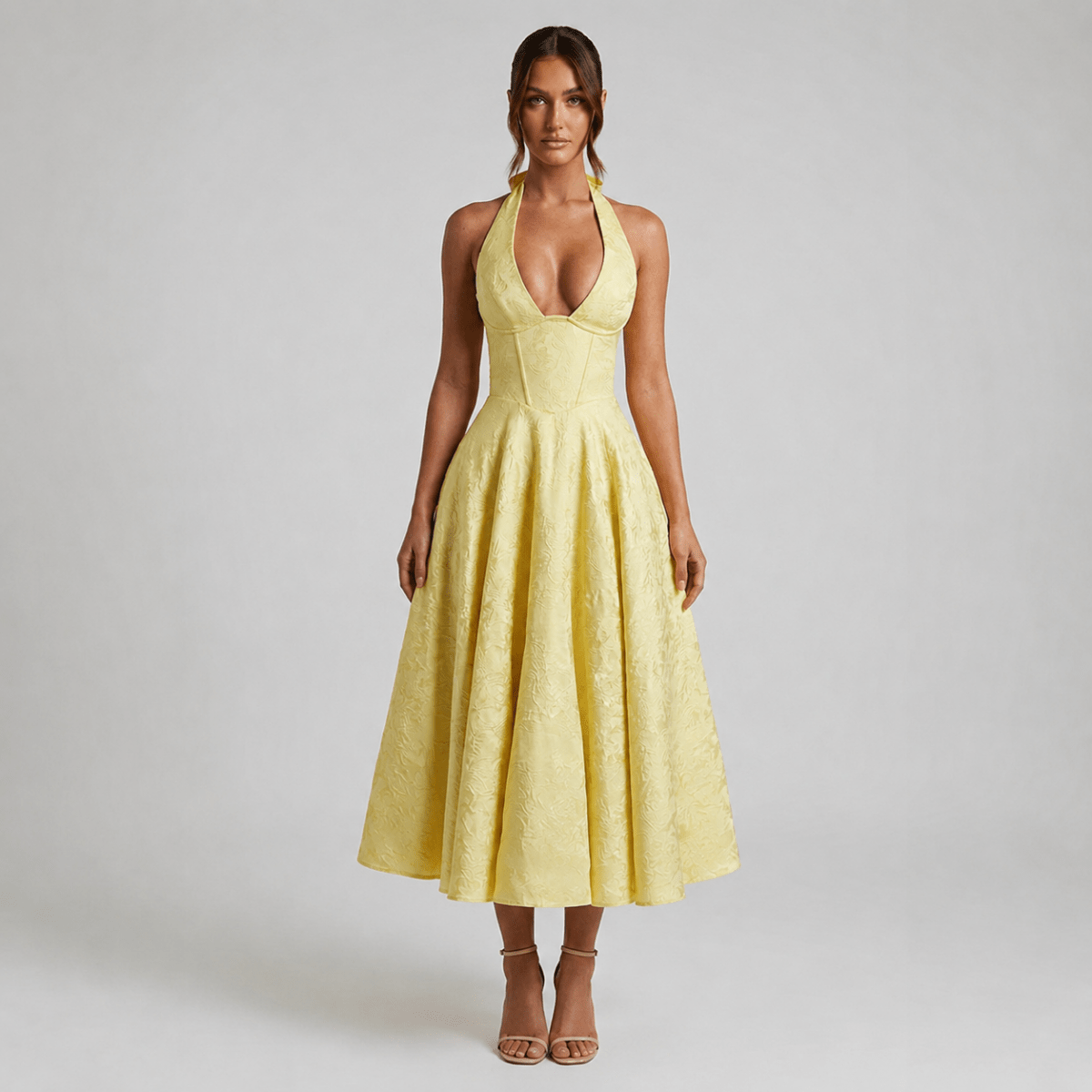 Front view of the Kouvr yellow floral jacquard halter corset midi dress featuring a plunging V-neckline and fit and flare skirt.