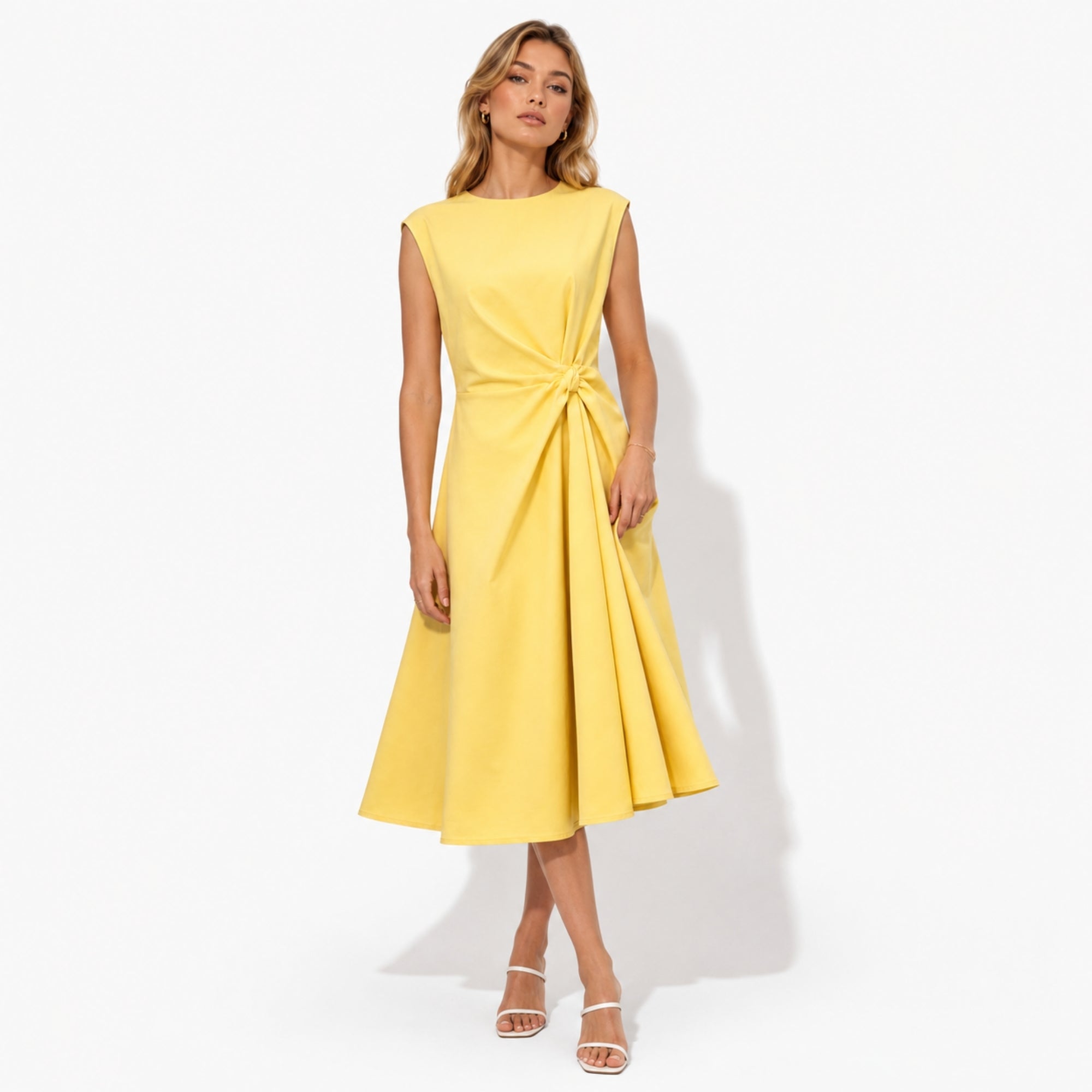 Front view of woman wearing Kouvr elegant yellow sleeveless midi dress featuring a flattering twist knot waist and flared A-line skirt.